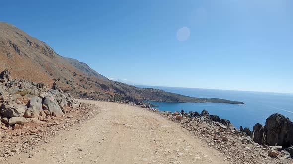 Car POV driving on a ground trail off road. Yellow sandstone, dirt sand trails. alt