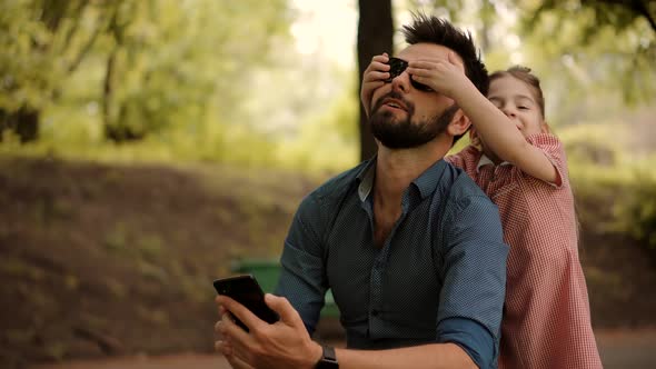 Family Cheerful Dad Playing Cute Little Child Daughter On Park. Girl Close Eyes Carefree Father. alt