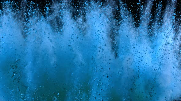 Super Slowmotion Shot of Blue Powder Explosion Isolated on Black Background alt