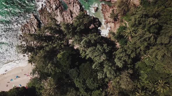 Aerial Top view over beach, ocean waves crashing on rocks and sand. beautiful tropical sea. Thailand