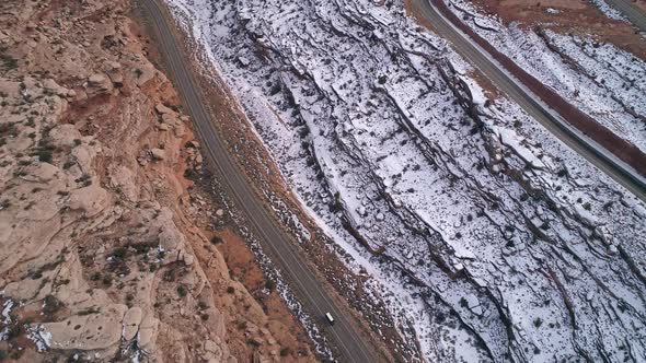 Aerial view of winding road with mail truck driving its route alt