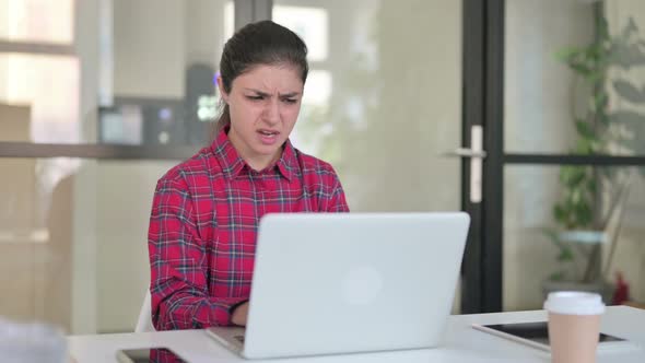 Indian Woman Reacting to Loss While Using Laptop alt