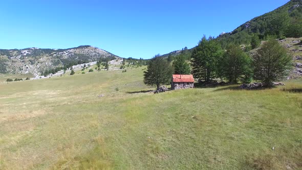 People sitting in front of brick mountain cabin alt