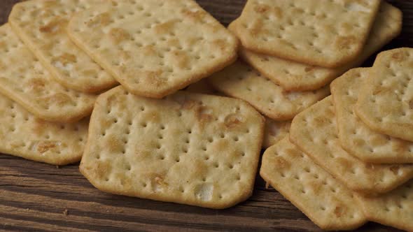Delicious dry crackers on a wooden table. Biscuits salty crackers.