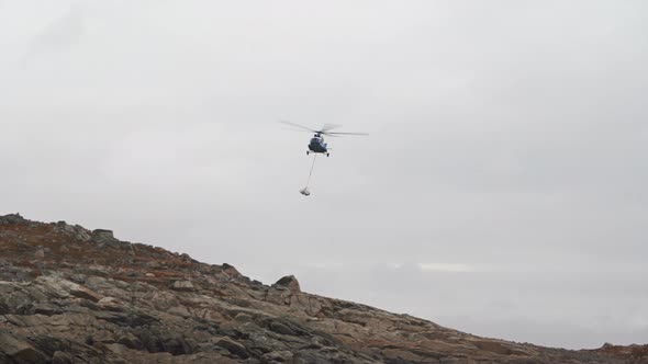 MI8 Helicopter Carries Cargo on the Sling