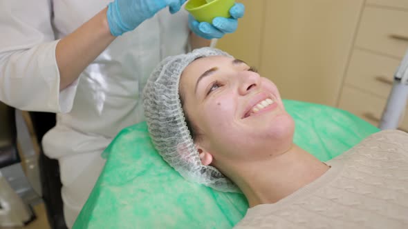 Young Woman Receiving Fruit Acid Peeling in Beauty Clinic alt