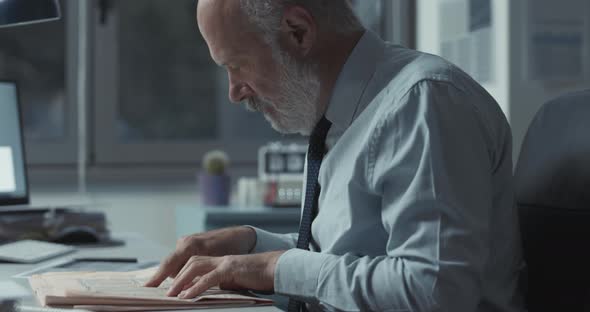 Successful stock broker checking stock market news on the newspaper