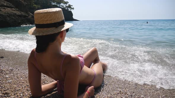 Sexy Woman Lying on Beach and Sunbathing Enjoying Sea Waves alt