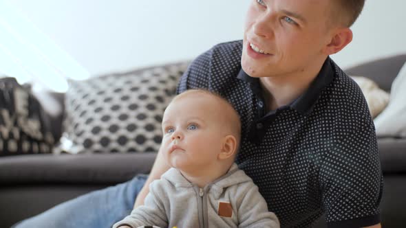 Beautiful Portrait Of Young Father And Baby