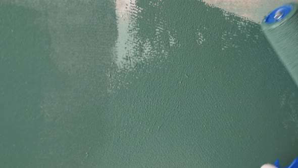Renovation Painting Walls with Blue Paint Using Brush Closeup alt