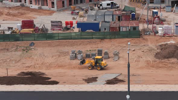 Construction of a Residential Complex in the City, the Tractor Levels the Ground, Timelapse.
