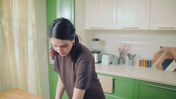 Young Caucasian Woman in Brown Tshirt Baking Cookies at Home Kitchen