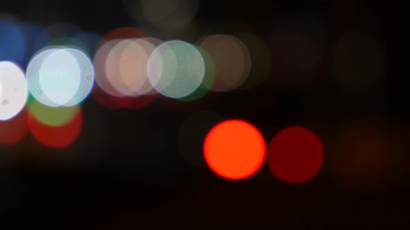 Beautiful Glittering Bokeh in Dark Blurry Background at Night
