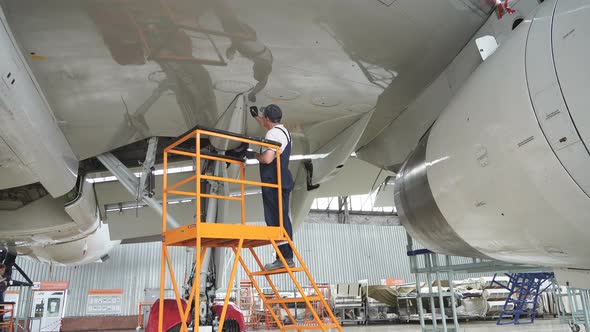 Maintenance of Passenger Aircraft. Repair of an Airplane Wing.  Passenger Plane in the Hangar alt