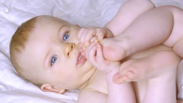 Cute Litte Baby Aeting His Legs.
