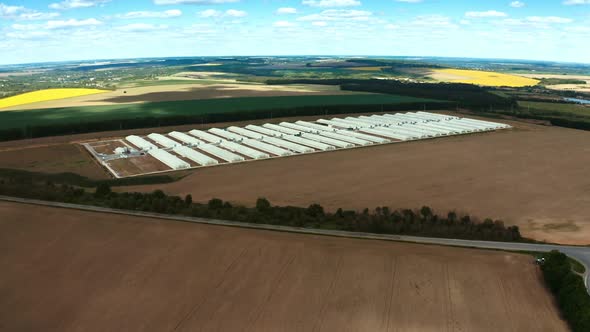 Exterior of large farm on an agricultural field.  alt