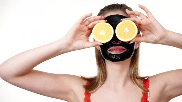 Girl Facial Black Mask Holds Orange Fruits