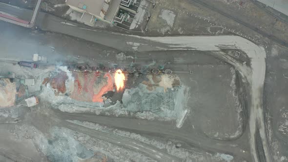 Pour Molten Slag From the Diesel Locomotive Tank at a Metallurgical Plant. Aerial View alt