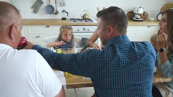 Group of Friends at Family Reunion Gathering Eating Meals and Passing Dishes alt