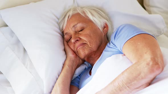 Senior woman sleeping in the bedroom alt