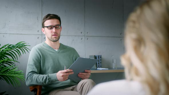 Young professional talking to a patient on a couch alt