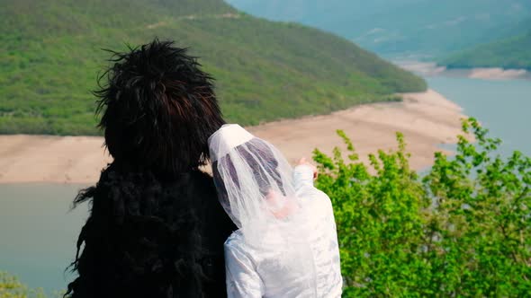 A Girl and a Man in a Papakha and National Georgian Costume alt