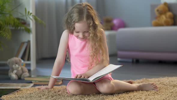 Little Kid Reading, Laughing at Funny Story in Childrens Book, Early ...