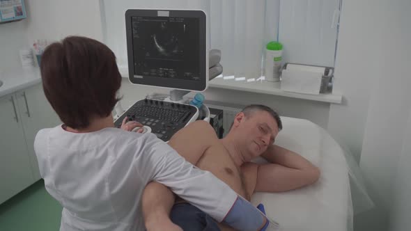 Doctor Doing a Doppler Sonography a Male Patient in a Cardiology Clinic alt