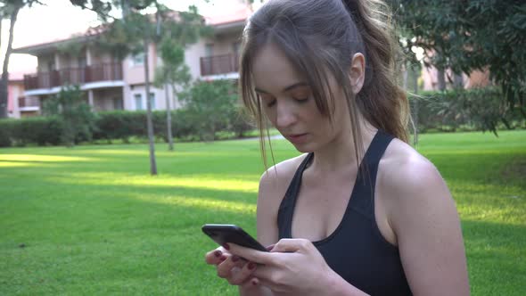 The girl goes in for sports, yoga, stretches, does gymnastics, morning exercises. A girl is watching alt