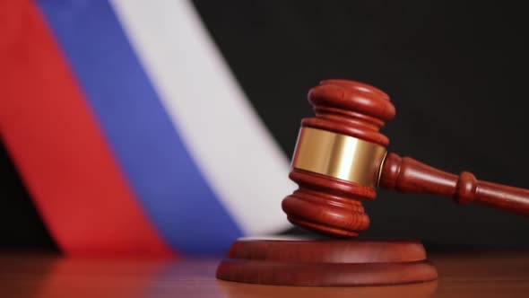 Judge Gavel on the Background of the Russian Flag
