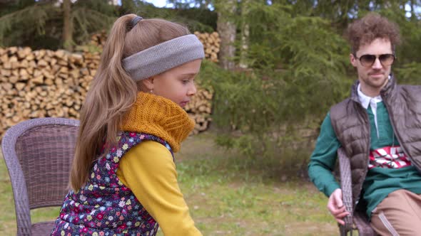 Little Cute Girl Fries Bread Slice at Stake, Enjoing Camping Picnic with Family