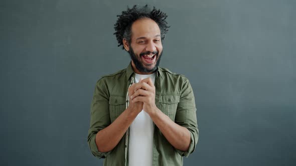 Slow Motion Portrait of Mean Arab Man Rubbing Hands Planning Evil Deeds Looking at Camera alt