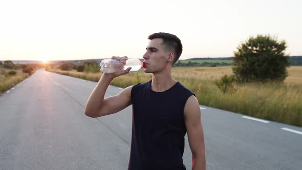 The Sportsman Drinking Bottle of Water and Pouring It on Face and Head ...