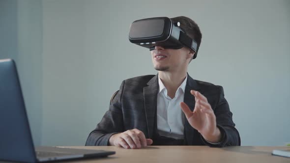 American Designer Get Virtual Experience Using Vr Glasses at Table with Laptop in Office.