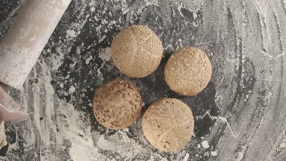 Hands Over the Fresh Baked Bread on the Table alt