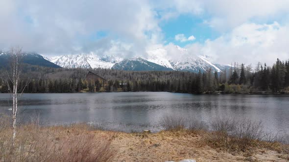 Aerial View of Strbske Pleso, Slovakia. Mountain Lake in Clouds and Snowy Tatras Mountains alt
