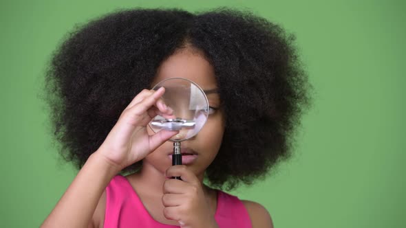 Young Cute African Girl with Afro Hair Playing with Fidget Spinner alt