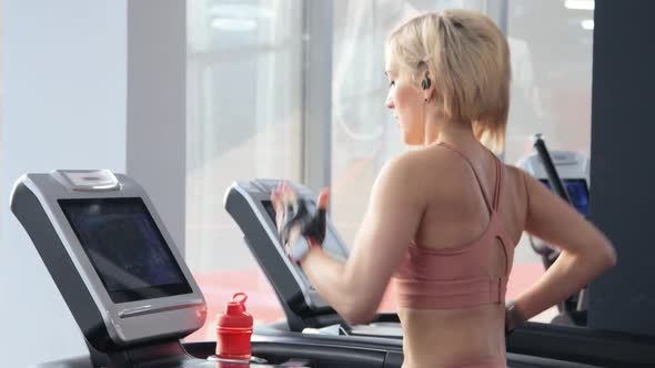 Young woman training on treadmill