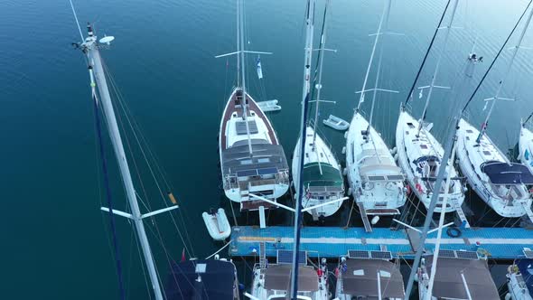Top down view of yachts in the marina. Sailboats and regular Boats moured alt