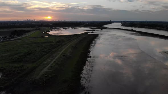 reflection of clouds during sunset at a fresh water tidal area in the Netherlands alt