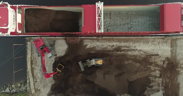 Cargo Ship Bulk Carrier Loading with Peat Soil Top Down Aerial View