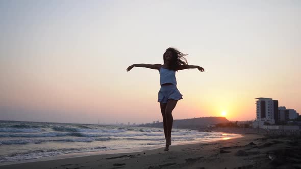Happy Woman Running Barefoot on Beach and Jumping with Excitement