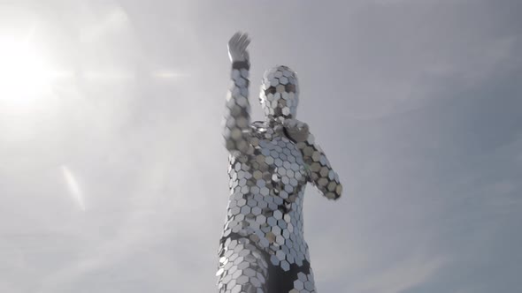 Sparkling Discosuit Man Dancing with Clouds Behind alt