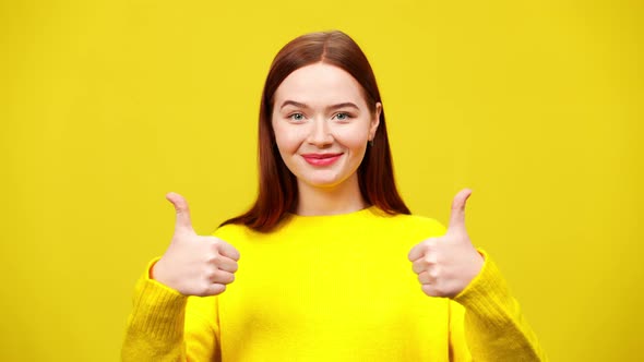 Portrait of Satisfied Young Redhead Woman Showing Thumbs Up Smiling at Camera alt