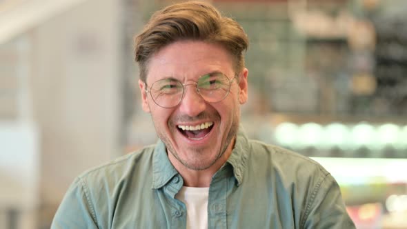 Portrait of Excited Middle Aged Man Feeling Surprised alt