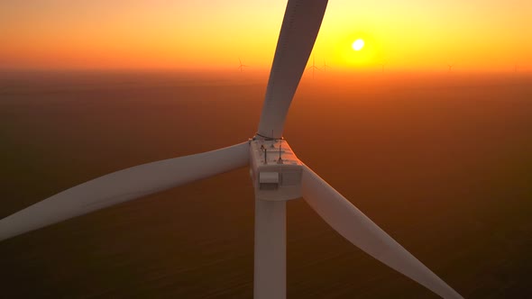 Wind Driven Generator with Large Blades Rotates at Sunset