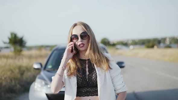 Stylish Business Woman in Sunglasses Speaks on the Phone alt