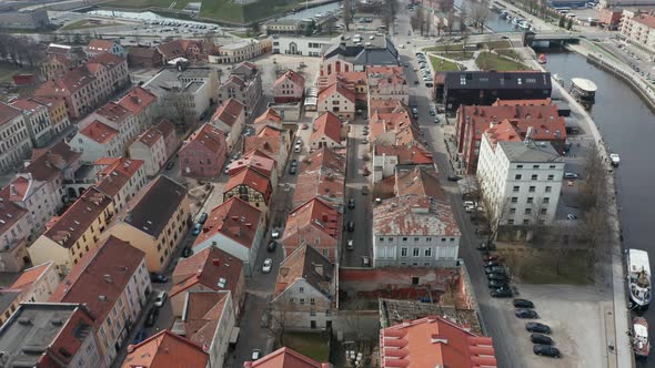 AERIAL: Klaipeda Old Town with Old Historic Houses and Traffic in Background