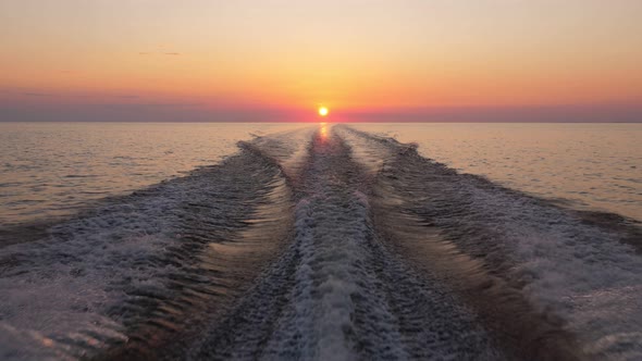 Ending of romantic water trip, sunset straight after boat running fast alt