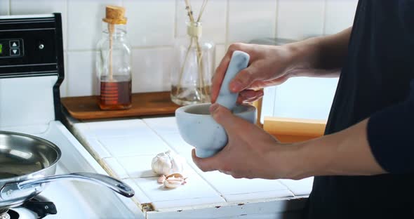 Man mixing ingredients in mortar and pestle 4k alt